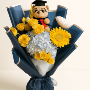 Brillo Académico Fioretta – Ramo con flores amarillas y celestes con osito de graduación.